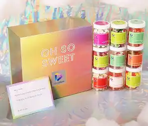 Colorful “Oh So Sweet” gift box with stacked jars of candy and a small message card.