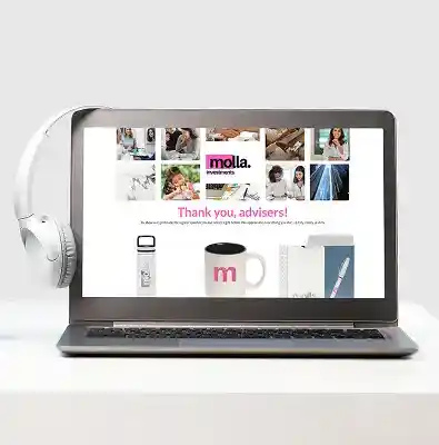 Laptop displaying a branded online gift storefront with product images; headphones rest beside the device.